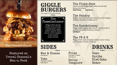 Giggle Burgers menu featuring 'The Commissioner' - a towering burger with Wagyu beef, gouda cheese, bacon strips, sugar pearl waffle, butcher block bacon, onion tanglers and cookie butter drizzle. Left side shows appetizing photo of the stacked burger. Menu lists other burgers including The Plain Jane, The Hendry, The Speakcheesy, and The PB & B, plus sides (Mac & Cheese, Tots, Fries, Onion Tanglers) and drinks. Note states 'Featured on Travel Channel's Man v. Food' and offers vegan Impossible Burger substitute.